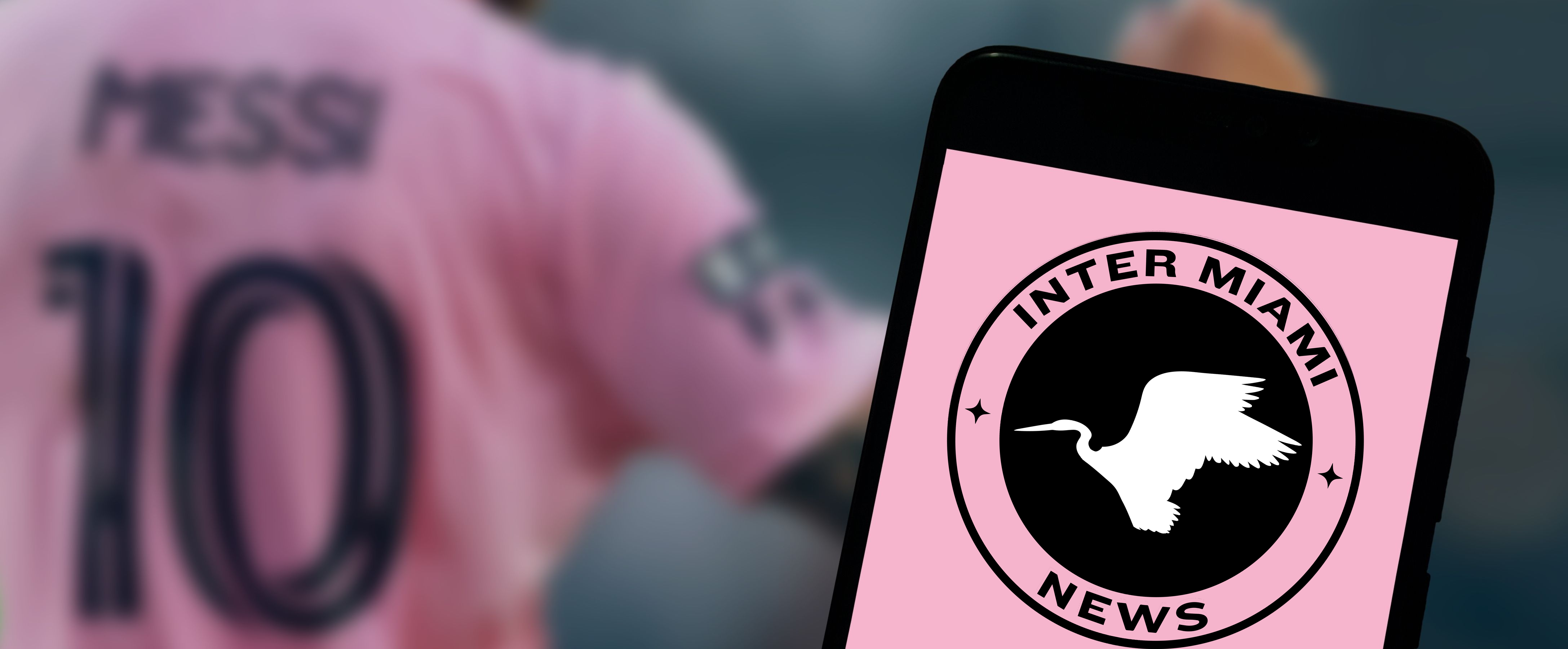 Inter Miami logo on a phone, with Messi blurred in the background